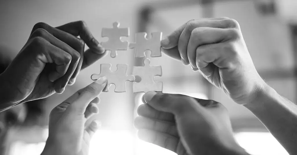 diverse-hands-connecting-puzzle-pieces-global-companies-coming-together